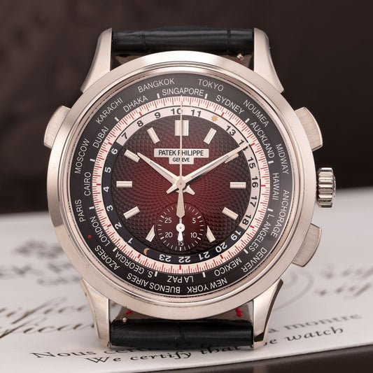 Luxury watch with a black strap on a dark background
Patek Philippe, World Time Chronograph Singapore Limited Edition 2019