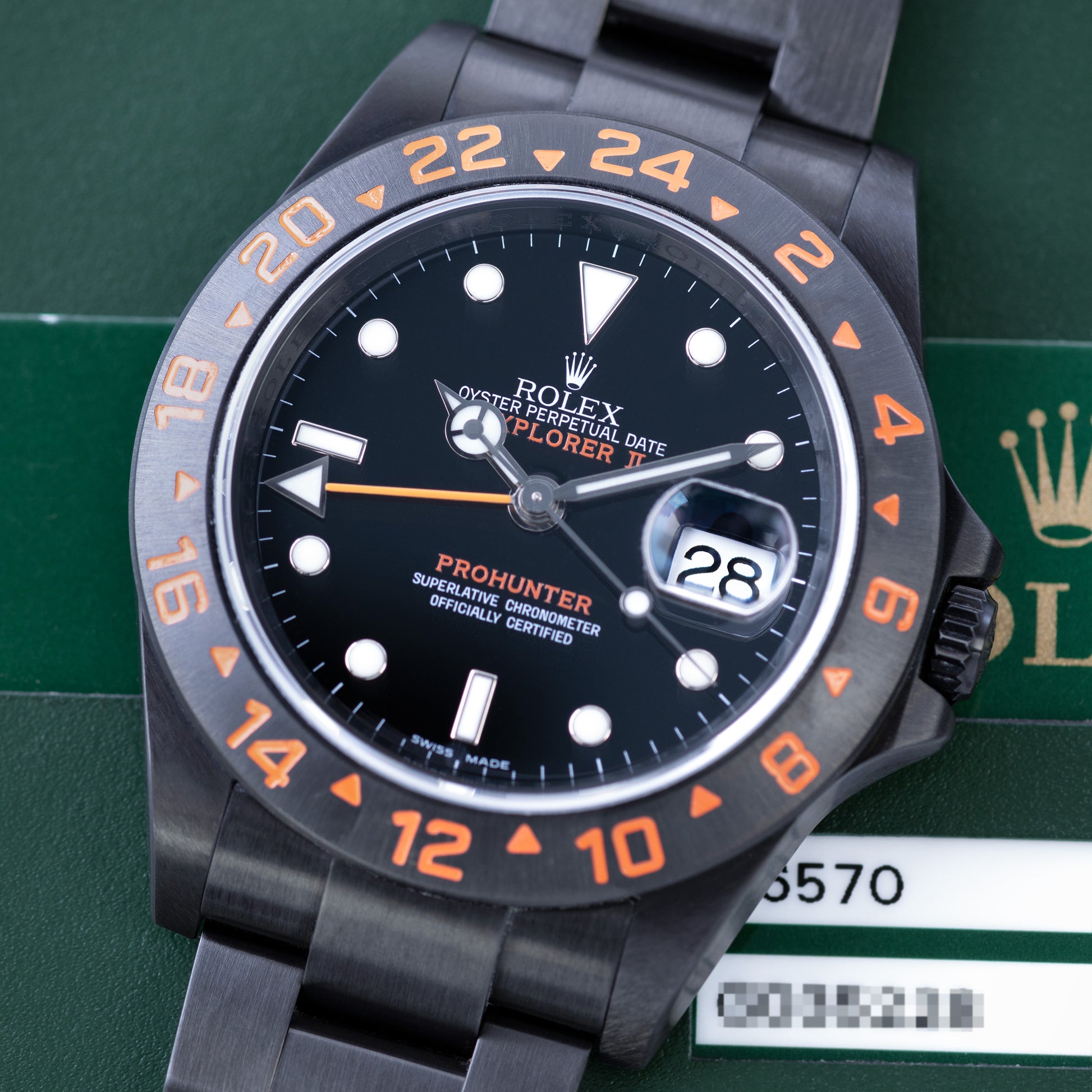 Black DLC Prohunetr Explorer II ref.16570 40mm close up with papers